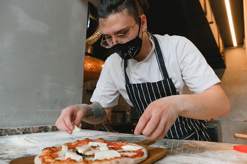 Open pizza bar where pizzas are crafted at Pizza Ranch